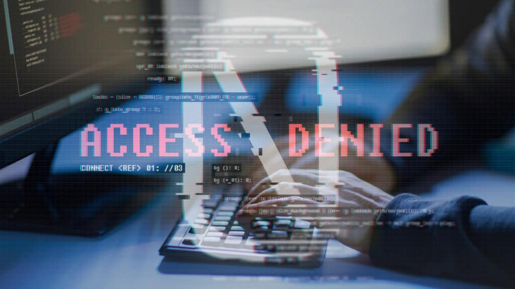 Handschlag vor Computer mit "Access Denied" Anzeige, symbolisiert Cyberbedrohungen.